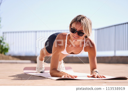 young caucasian woman in plank position, exercising outdoors. stretch whole body, lead healthy young caucasian woman in plank position, exercising outdoors. stretch whole body, lead healthy 113538919