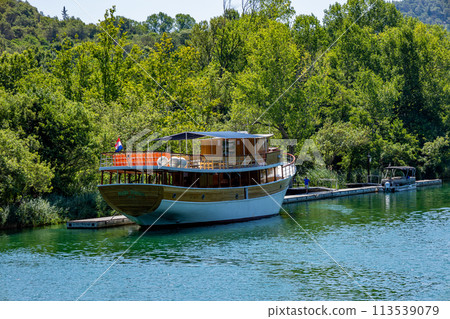 Waterfalls Krka, Croatia. Natural Waterfalls. A tourism boat. Krka National Park, Croatia 113539079