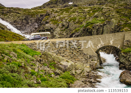 Car with canoe on top in mountains Car with canoe on top in mountains 113539153