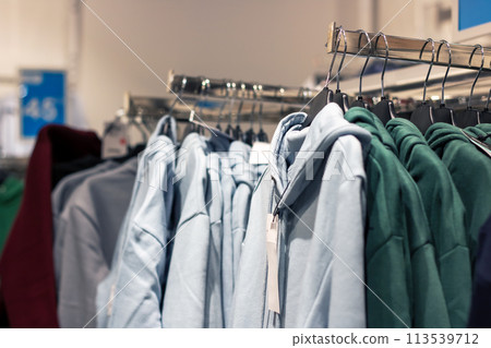 Jackets on hangers in a shop window Jackets on hangers in a shop window 113539712