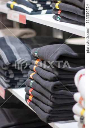 Jackets on hangers in a shop window 113539714