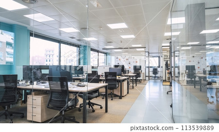 Interior of creative coworking workspace with computer desks 113539889