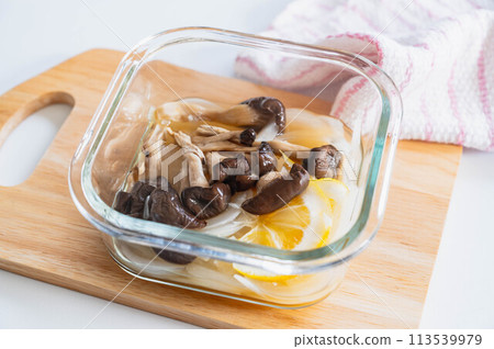 Oyster mushrooms and new onions simmered in lemon in the microwave 113539979