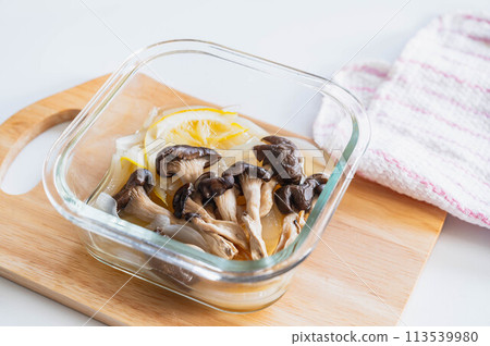 Oyster mushrooms and new onions simmered in lemon in the microwave 113539980