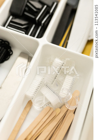 Manicure and pedicure tools. Nail file and cuticle pusher orange wood sticks. Top view Manicure and pedicure tools. Nail file and cuticle pusher orange wood sticks. Top view 113541085