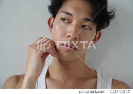 Young man in white tank top Young man in white tank top 113541997