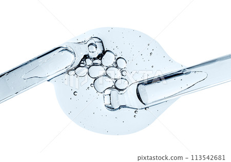 Two pipettes and a drop of cosmetic serum for the skin. Liquid body care product. Macrophotography. Isolated on a white background. 113542681
