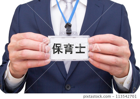 A man holding a nursery teacher's name tag 113542701