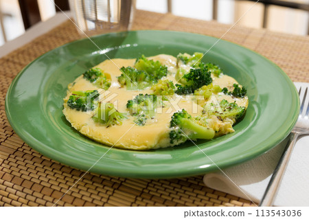 Wholesome breakfast. omelet with broccoli on green plate 113543036