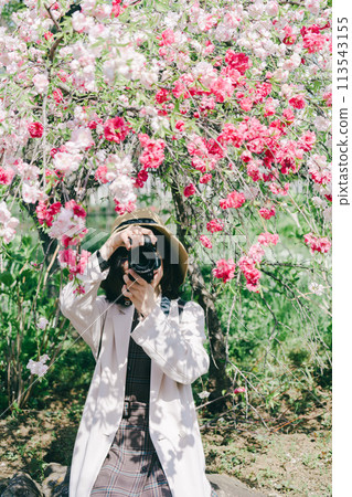 A woman shooting flowers 113543155