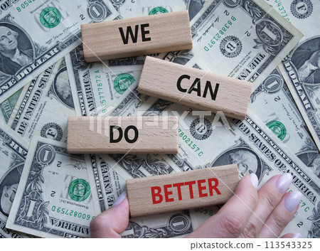 We Can Do Better symbol. Concept words We Can Do Better on wooden blocks. Beautiful dollar background. Businessman hand. Business and We Can Do Better concept. Copy space. We Can Do Better symbol. Concept words We Can Do Better on wooden blocks. Beautiful dollar background. Businessman hand. Business and We Can Do Better concept. Copy space. 113543325