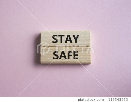 Stay Safe symbol. Concept word Stay Safe on wooden blocks. Beautiful pink background. Business and Stay Safe concept. Copy space 113543953