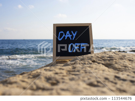 Day off symbol. Day off black chalk blackboard. Beautiful sea background. Business and Day off concept. Copy space. 113544676