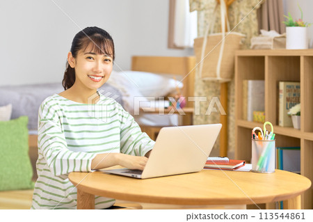 Teleworking young business woman doing desk work at home Teleworking young business woman doing desk work at home 113544861