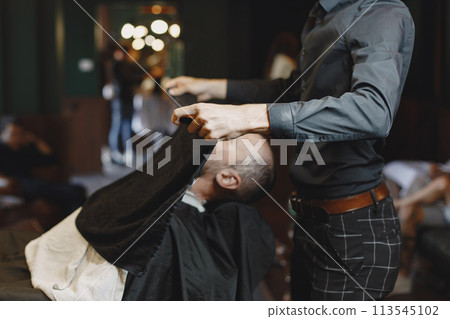 Man with a beard. Hairdresser with a client. Man with a comb and scissors Man with a beard. Hairdresser with a client. Man with a comb and scissors 113545102