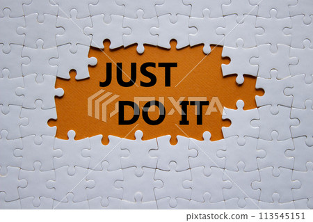 Just do it symbol. Concept words Just do it on white puzzle. Beautiful orange background. Business and Just do it concept. Copy space. 113545151