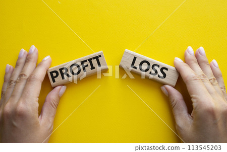 Profit or Loss symbol. Concept word Profit or Loss on wooden blocks. Businessman hand. Beautiful yellow background. Business and Profit or Loss concept. Copy space Profit or Loss symbol. Concept word Profit or Loss on wooden blocks. Businessman hand. Beautiful yellow background. Business and Profit or Loss concept. Copy space 113545203