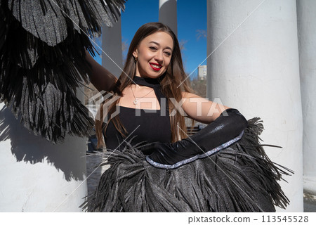 a girl in a black suit and angel wings on the background of the rotunda and the sky a girl in a black suit and angel wings on the background of the rotunda and the sky 113545528