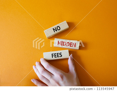 No hidden fees symbol. Concept word No hidden fees on wooden blocks. Businessman hand. Beautiful orange background. Business and No hidden fees concept. Copy space 113545947