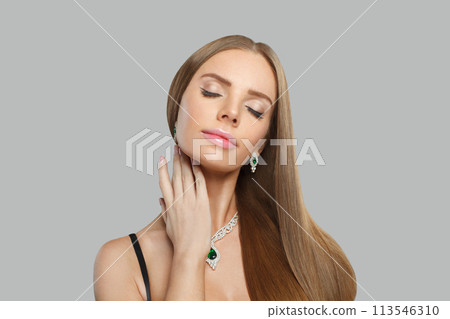 Lovely woman with makeup wearing jewelry necklace with sapphire and diamond on grey background 113546310