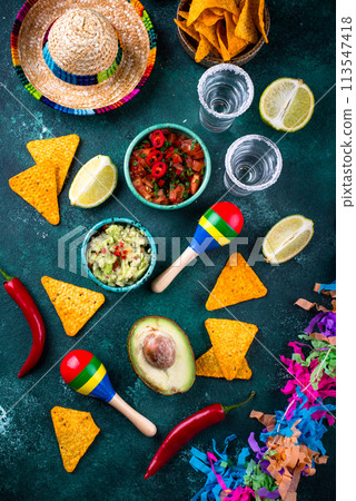 Traditional Mexican food nachos, salsa, guacamole, tequila. 113547418