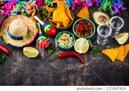 Traditional Mexican food nachos, salsa, guacamole, tequila. 113547424