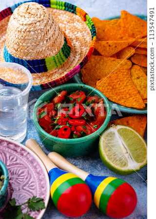 Traditional Mexican food nachos, salsa, guacamole, tequila. 113547491