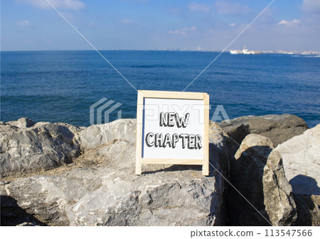 New Chapter symbol. Concept word New Chapter on white chalk background. Beautiful sea background. Business and New Chapter concept. Copy space 113547566
