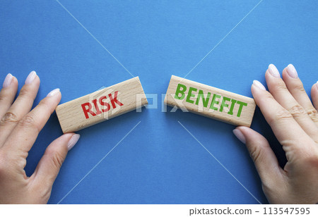 Risk or Benefit symbol. Concept word Risk or Benefit on wooden blocks. Businessman hand. Beautiful blue background. Business and Risk or Benefit concept. Copy space Risk or Benefit symbol. Concept word Risk or Benefit on wooden blocks. Businessman hand. Beautiful blue background. Business and Risk or Benefit concept. Copy space 113547595