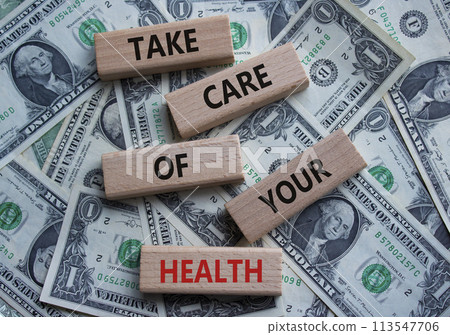 Health symbol. Wooden blocks with words Take Care of your Health. Beautiful dollar background. Health concept. Copy space. 113547706