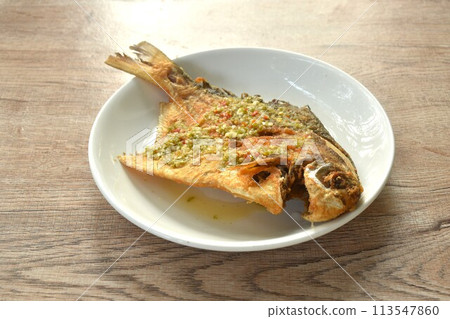 crispy fried white butterfish or silver pomfret arranging dressing Thai spicy seafood chili on plate  113547860