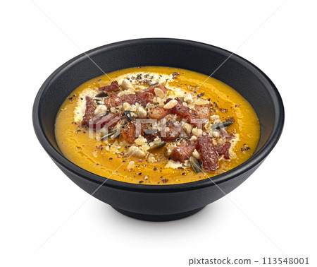 Pumpkin cream soup with pumpkin seeds and crispy bacon isolated on white background, package design element Pumpkin cream soup with pumpkin seeds and crispy bacon isolated on white background, package design element 113548001