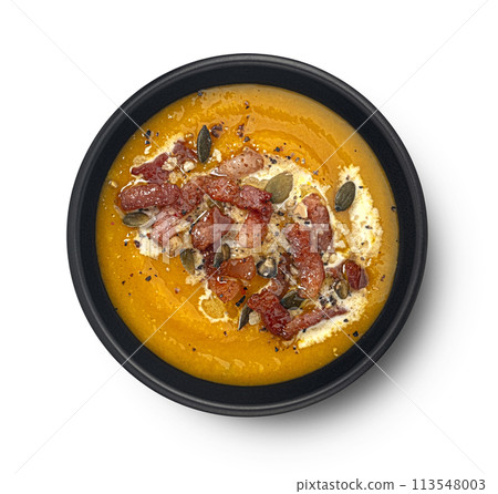Pumpkin cream soup with pumpkin seeds and crispy bacon isolated on white background, top view, package design element Pumpkin cream soup with pumpkin seeds and crispy bacon isolated on white background, top view, package design element 113548003