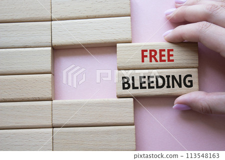 Free bleeding symbol. Concept words Free bleeding on wooden blocks. Beautiful pink background. Hand. Motivational and Free bleeding concept. Copy space. 113548163