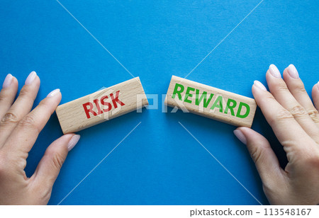 Risk or Reward symbol. Concept word Risk or Reward on wooden blocks. Businessman hand. Beautiful blue background. Business and Risk or Reward concept. Copy space Risk or Reward symbol. Concept word Risk or Reward on wooden blocks. Businessman hand. Beautiful blue background. Business and Risk or Reward concept. Copy space 113548167