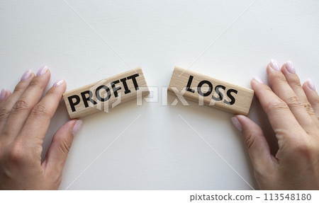 Profit or Loss symbol. Concept word Profit or Loss on wooden blocks. Businessman hand. Beautiful white background. Business and Profit or Loss concept. Copy space 113548180