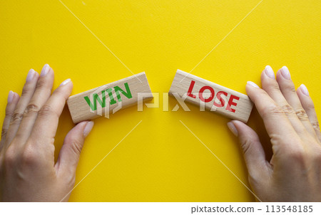 Win or Lose symbol. Concept word Win or Lose on wooden blocks. Businessman hand. Beautiful yellow background. Business and Win or Lose concept. Copy space 113548185