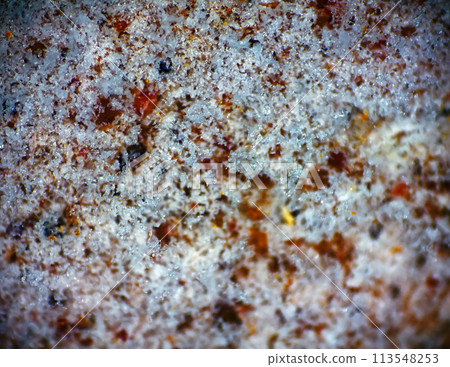 Thin layer of melting snow on stone 113548253