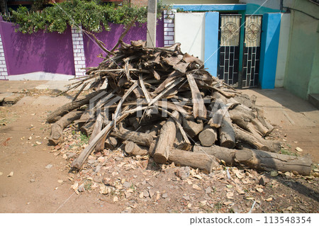 Indian village. Firewood stacked in pile in front of house Indian village. Firewood stacked in pile in front of house 113548354