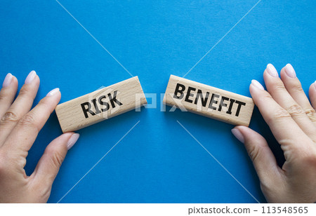 Risk or Benefit symbol. Concept word Risk or Benefit on wooden blocks. Businessman hand. Beautiful blue background. Business and Risk or Benefit concept. Copy space Risk or Benefit symbol. Concept word Risk or Benefit on wooden blocks. Businessman hand. Beautiful blue background. Business and Risk or Benefit concept. Copy space 113548565