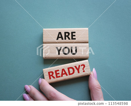 Are you ready symbol. Concept word Are you ready on wooden blocks. Businessman hand. Beautiful green grey background. Business and Are you ready concept. Copy space Are you ready symbol. Concept word Are you ready on wooden blocks. Businessman hand. Beautiful green grey background. Business and Are you ready concept. Copy space 113548598