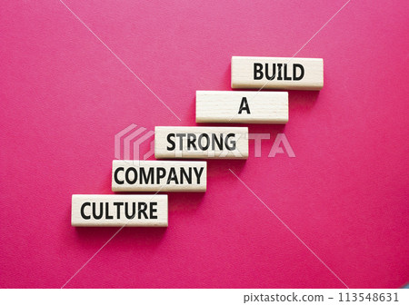 Company culture symbol. Wooden blocks with words Build a strong company culture. Beautiful red background. Business and Company culture concept. Copy space. Company culture symbol. Wooden blocks with words Build a strong company culture. Beautiful red background. Business and Company culture concept. Copy space. 113548631