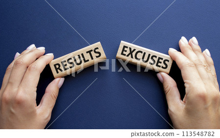 Results or Excuses symbol. Concept word Results or Excuses on wooden blocks. Businessman hand. Beautiful deep blue background. Business and Results or Excuses concept. Copy space 113548782