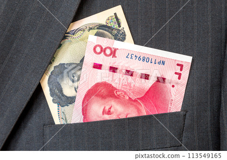 Banknotes of Japanese and Chinese currency sticking out of the pocket Banknotes of Japanese and Chinese currency sticking out of the pocket 113549165