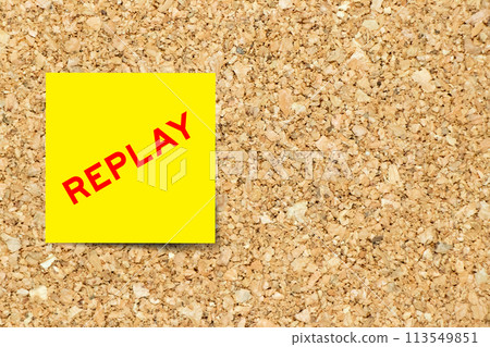 Yellow note paper with word replay on cork board background with copy space 113549851