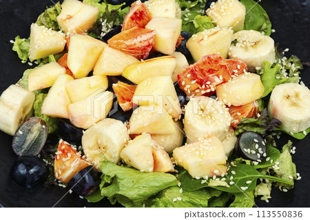 Fruit salad with oranges, closeup. Fruit salad with oranges, closeup. 113550836