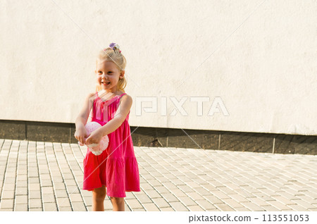 Funny baby with cochlear implant walks outdoor. Hearing aid and medicine innovating technology concept. Diversity and inclusion. Copy space 113551053