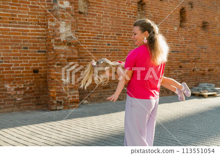 Mother holds and have fun her child with hearing aids and cochlear implants summer outdoor . Deaf and health concept. Diversity and inclusion. Copy space 113551054