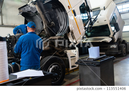 Truck repair service indoors. Maintenance workshop. Truck repair service indoors. Maintenance workshop. 113551406