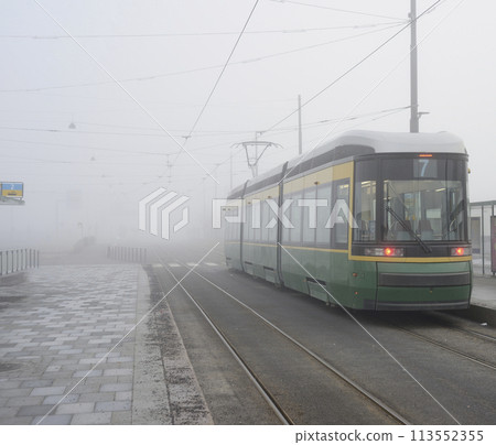 city tram number 7 at a stop early in the morning in the fog i 113552355